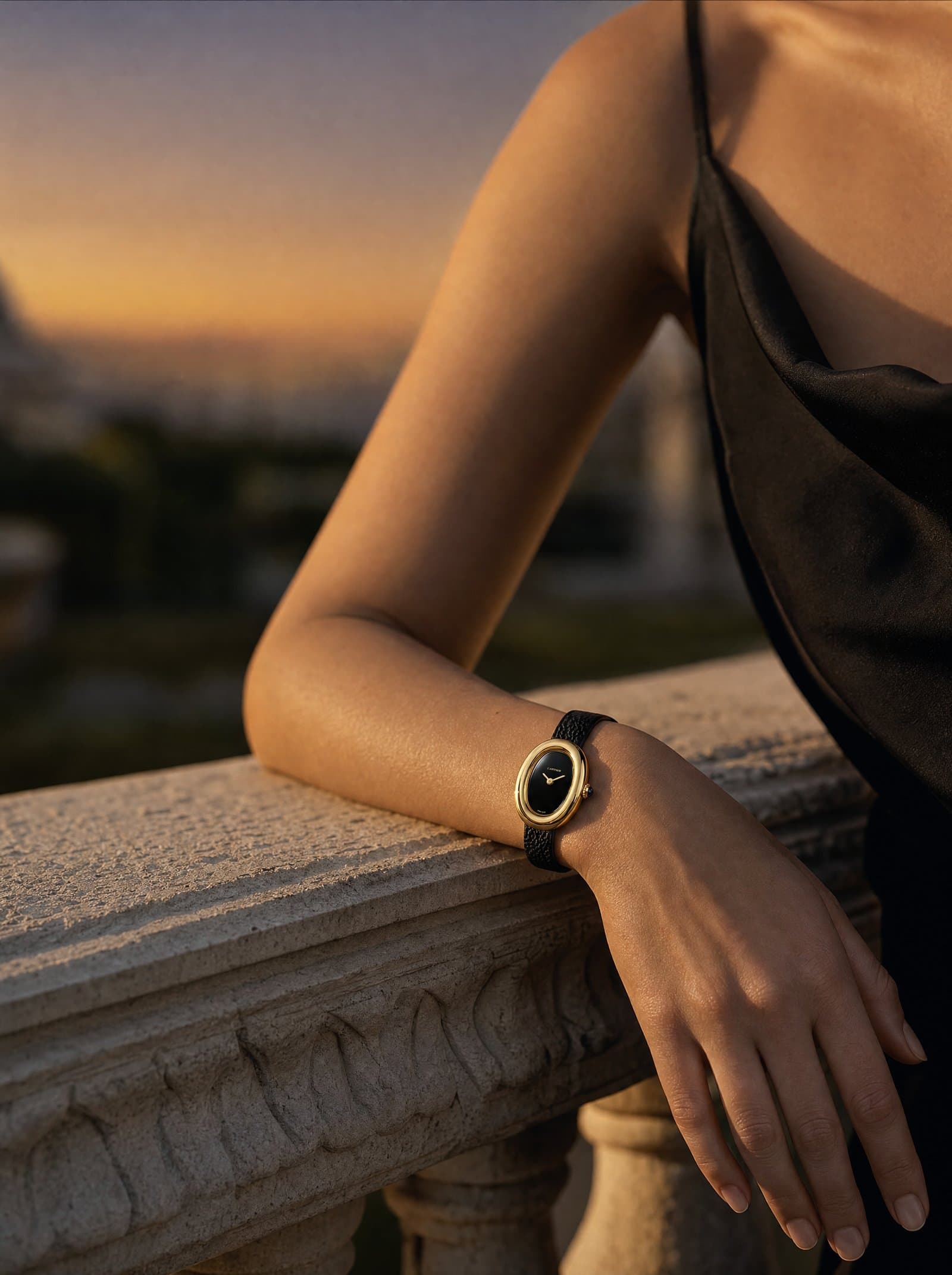 A yellow-gold Baignoire on a slim wrist at dusk