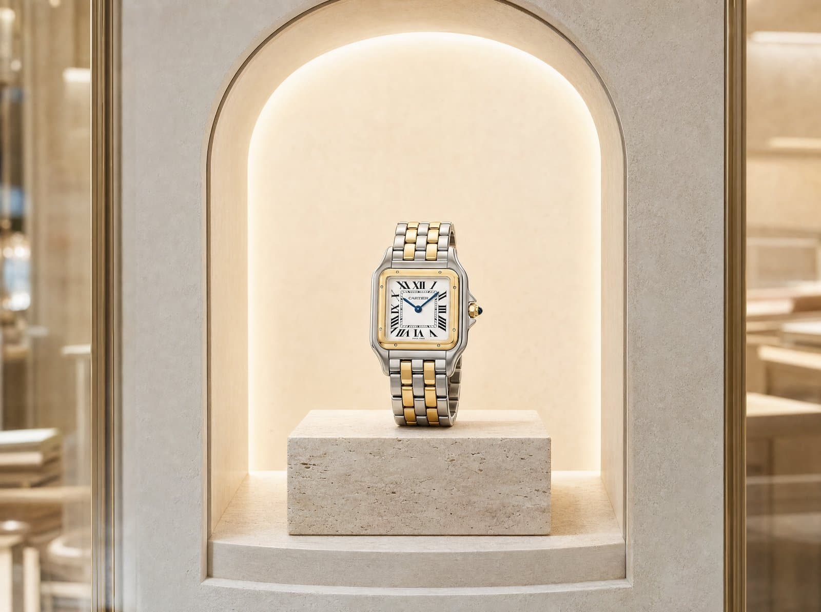 A yellow-gold Panthère on a boutique vitrine plinth