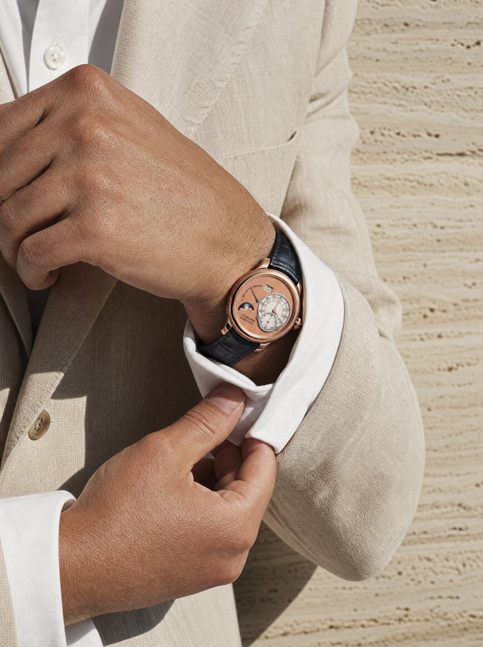 A salmon-dial Octa under a linen cuff