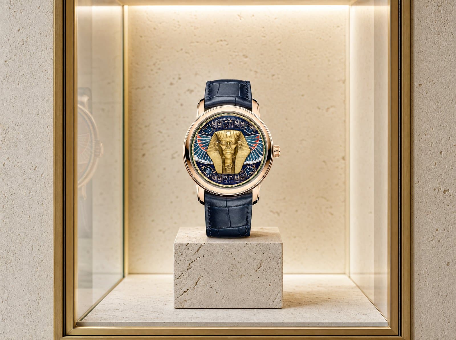 A pink-gold Métiers d'Art piece on a boutique plinth
