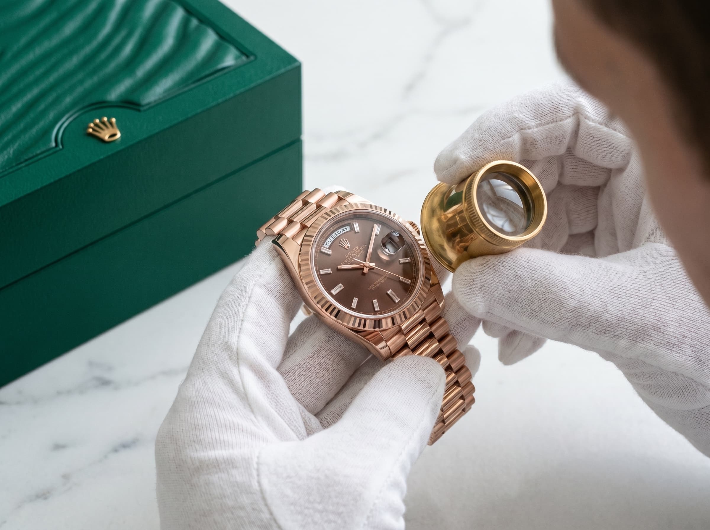 A specialist examining a timepiece under the loupe