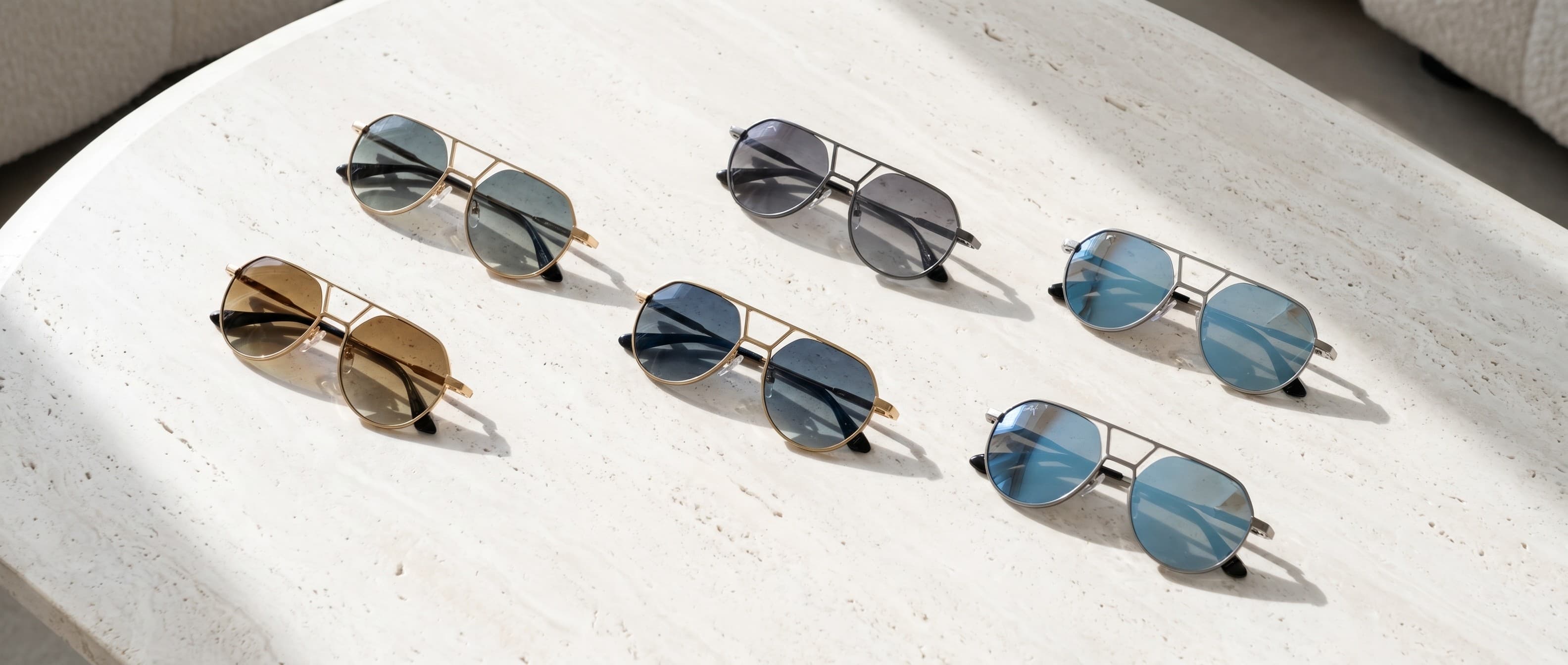 The Maison Soletti collection — hand-finished Italian acetate, several colourways on travertine