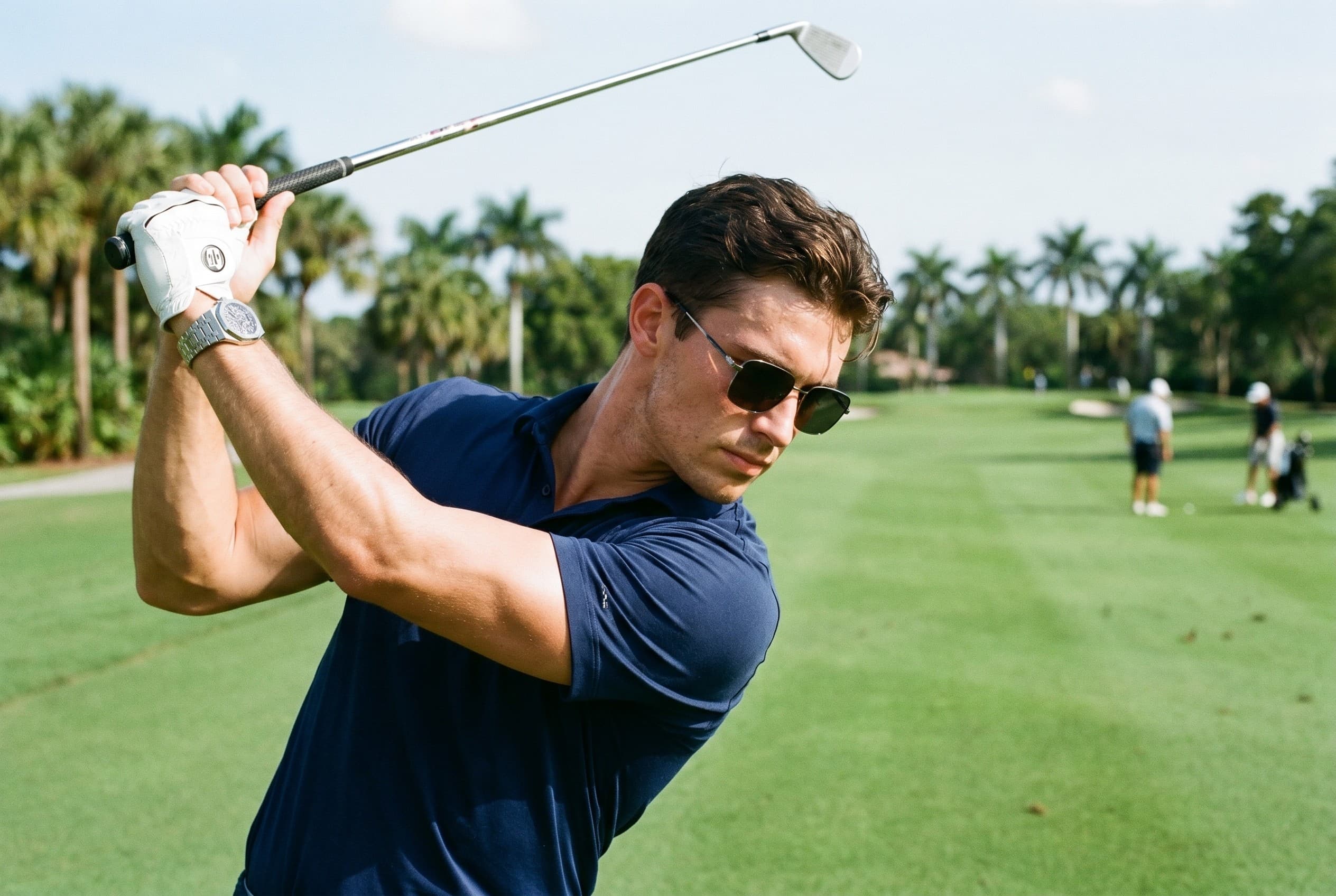 A man golfer mid-swing in Soletti frames with an Audemars Piguet
