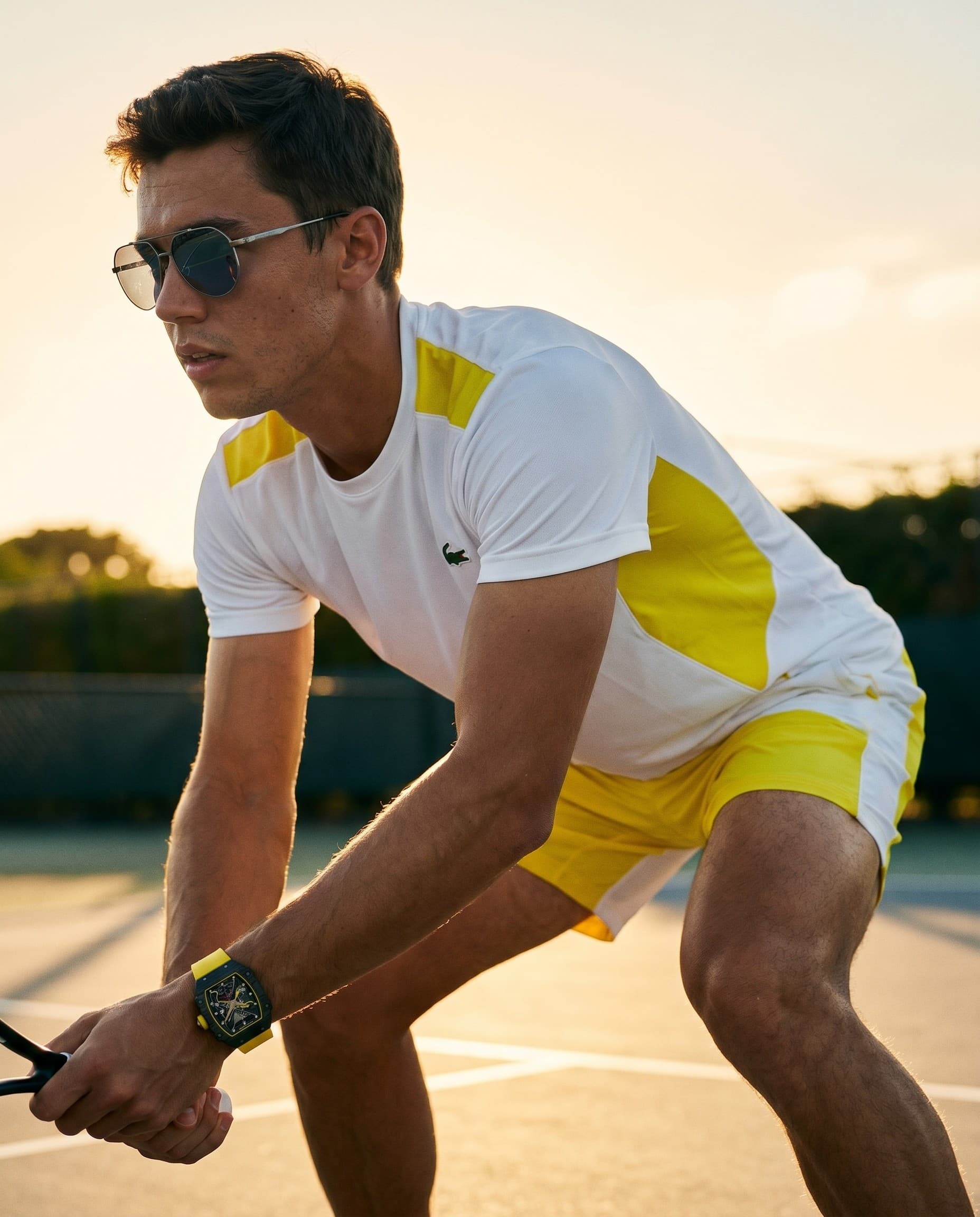 A tennis player in a yellow kit with a Richard Mille RM 67-02