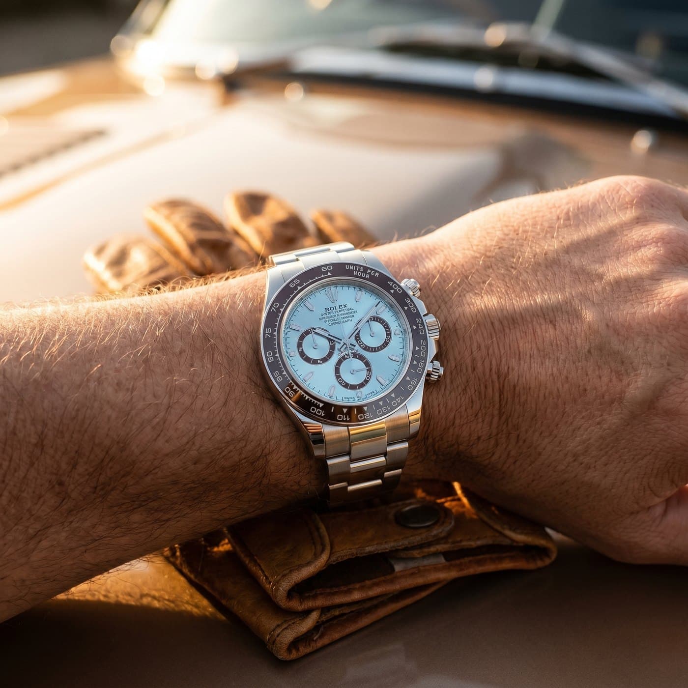 Driving gloves and a platinum Daytona on the wrist